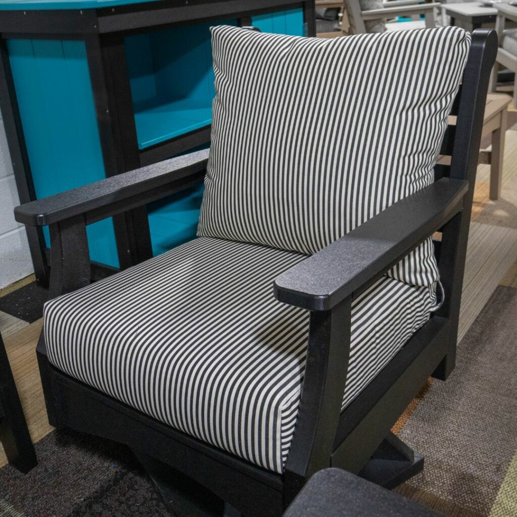 a black chair with black and white stripped cushions