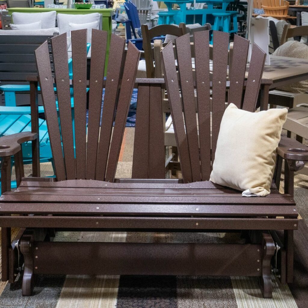 a brown adirondack chair gliding bench