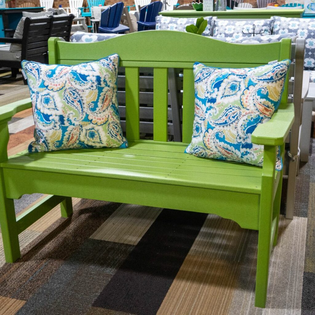 a green bench with pillows