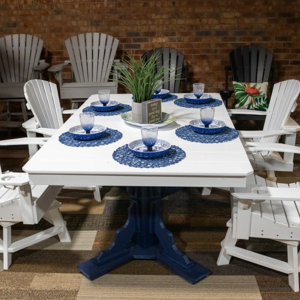 White dining table with blue decor and white chairs