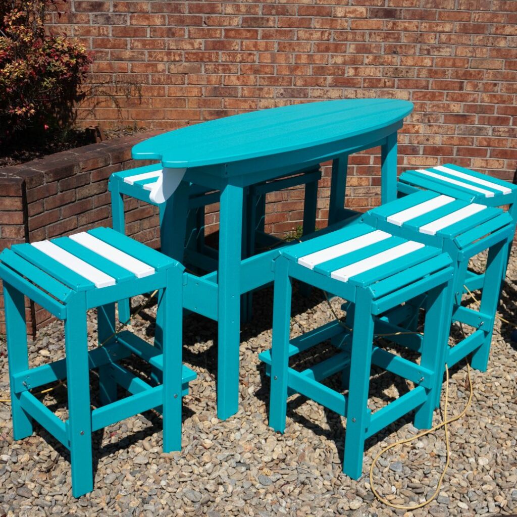 Turquoise table with matching stools in a gravel area